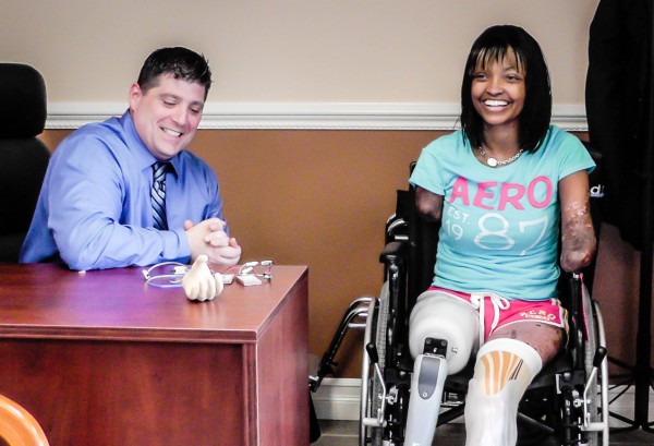 Chris Berger, C.P.O., helps patient Shannon Smith